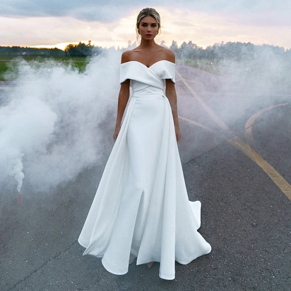 Sheath dress – Form-fitting dress that hugs the body and typically hits just above or at the knee.Sheath dress – Form-fitting dress that hugs the body and typically hits just above or at the knee.Simple Off the Shoulder Satin Sheath Ruched Wedding Dress With Detachable Overskirt